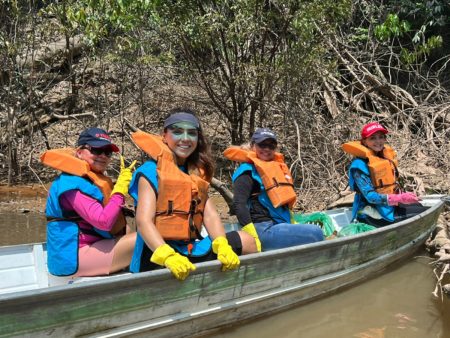 Colleagues collect trash from the Amazon River.